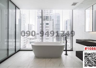 Modern bathroom with freestanding tub and city view