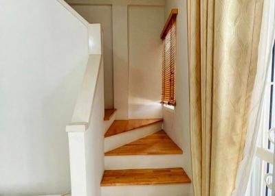 Bright staircase with wooden steps and handrail