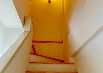 Brightly lit staircase with yellow walls