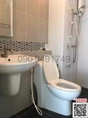 Modern bathroom interior with white fixtures and tiled floor