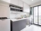 Modern kitchen with white cabinetry and natural light