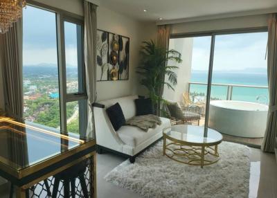 Spacious living room with ocean view, modern furniture, and an elegant bathtub