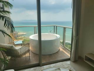 Elegant bedroom with a luxurious Jacuzzi overlooking a scenic sea view