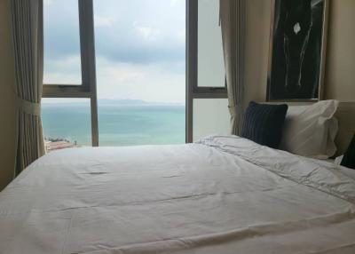 Bedroom with panoramic ocean view through large windows