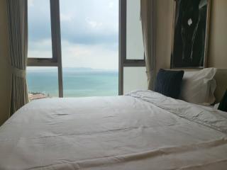 Bedroom with panoramic ocean view through large windows