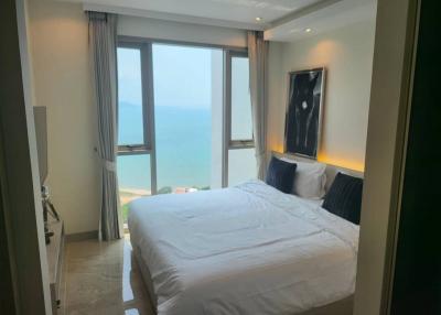 Spacious bedroom with ocean view and ample natural light