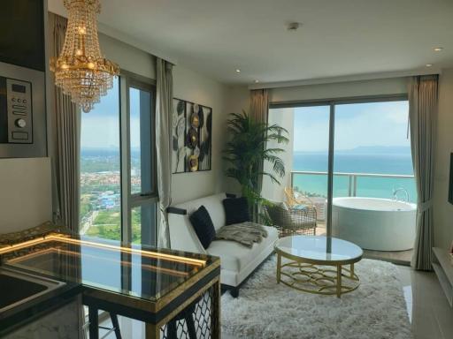 Luxurious living room with ocean view, modern furnishings, and open-concept design