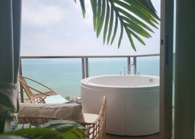 Spacious balcony with a large hot tub overlooking the sea