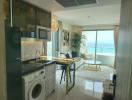 Modern apartment interior with an open plan kitchen, living area and a balcony with ocean view