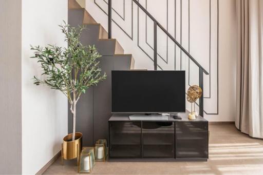 Modern living room interior with television and staircase