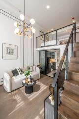 Modern living room with open concept, natural lighting, and a mezzanine level