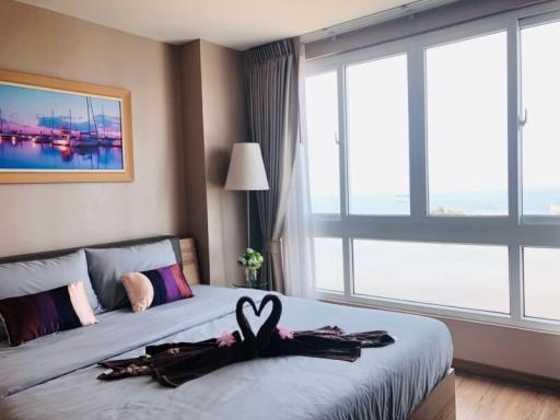 Modern bedroom interior with large windows and ocean view