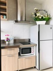 Modern kitchen with stainless steel appliances and wooden cabinets