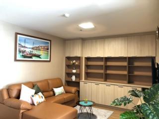 Spacious living room with modern furnishings and built-in shelving units