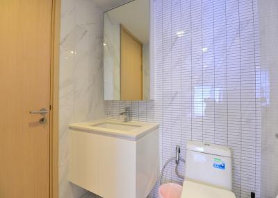 Modern bathroom with marble tiles and wooden cabinet