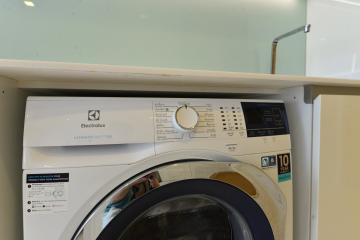 Front-loading Electrolux washing machine in a home laundry room