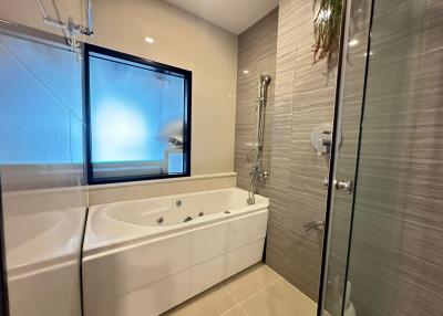Modern bathroom with jacuzzi tub and glass shower