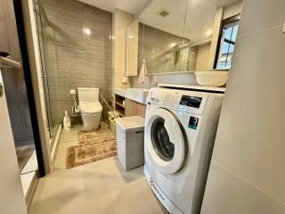 Modern bathroom with laundry appliances