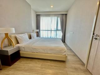 Modern bedroom with large bed and natural light