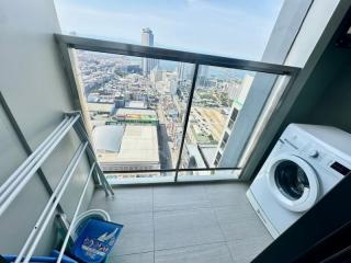 High-rise apartment laundry room with city view