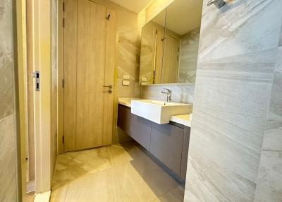 Modern bathroom with beige tiles and sleek fixtures