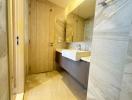 Modern bathroom with beige tiles and sleek fixtures