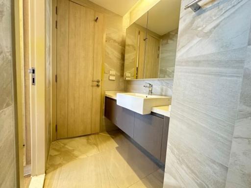 Modern bathroom with beige tiles and sleek fixtures