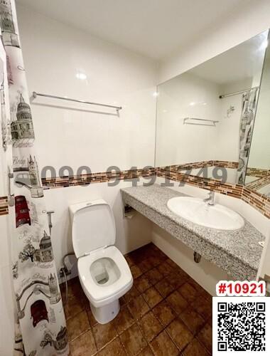 Spacious white-themed bathroom with tiled flooring