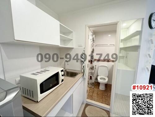 Modern kitchen with adjacent bathroom visible