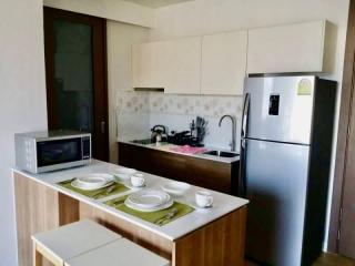 Modern kitchen with well-equipped appliances and breakfast counter