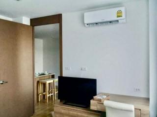 Modern living room with flat-screen TV and air conditioning unit