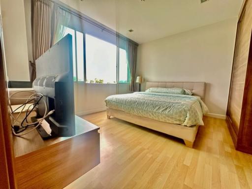 Spacious bedroom with a large bed and floor-to-ceiling windows