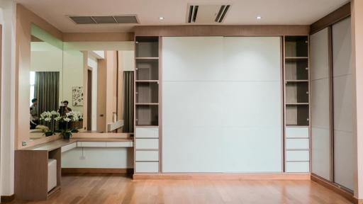 Modern bedroom interior with sliding wardrobe doors and vanity area