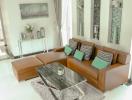 Modern and bright living room with leather sofa and glass coffee table