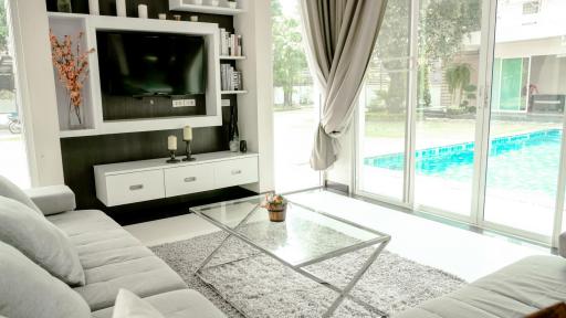 Modern and bright living room with pool view