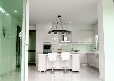 Modern kitchen with center island and elegant pendant lighting