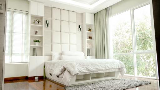 Bright bedroom with large window and modern design