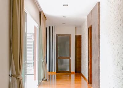 Spacious hallway with polished wooden flooring and natural light