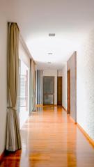 Spacious hallway with polished wooden flooring and natural light