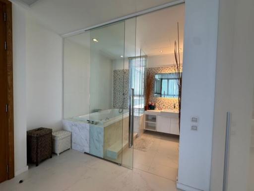 Modern bathroom with glass-enclosed shower and marble finishes