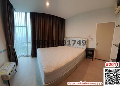 Spacious Bedroom with Large Window and City View