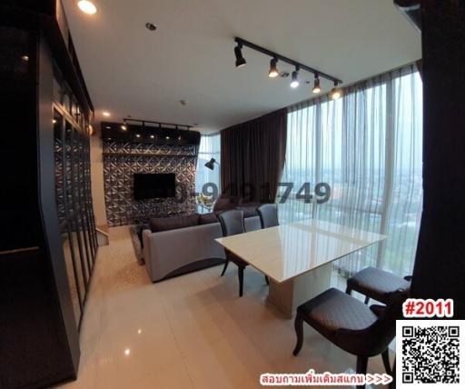 Spacious and modern living room with dining area and large windows