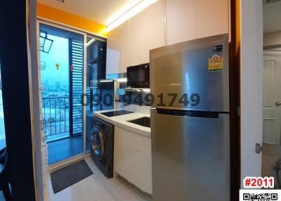 Modern kitchen with stainless steel appliances and balcony access