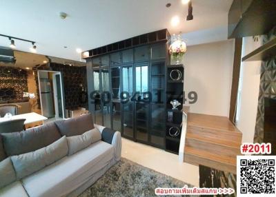 Modern living room with a grey sofa and glass shelving