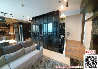 Modern living room with a grey sofa and glass shelving