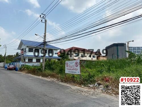 Street view of a house with a blue roof and advertisement sign in the foreground