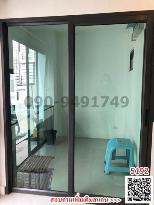 Compact balcony area with glass door and tiled floor