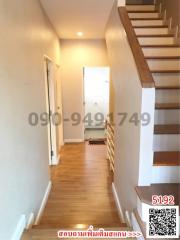 Hallway with wooden floors and staircase