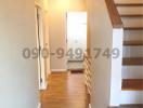 Hallway with wooden floors and staircase