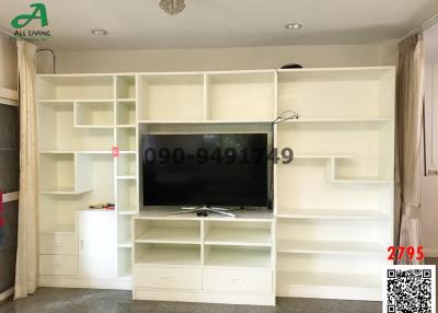 Spacious living room with modern built-in white shelving and entertainment unit